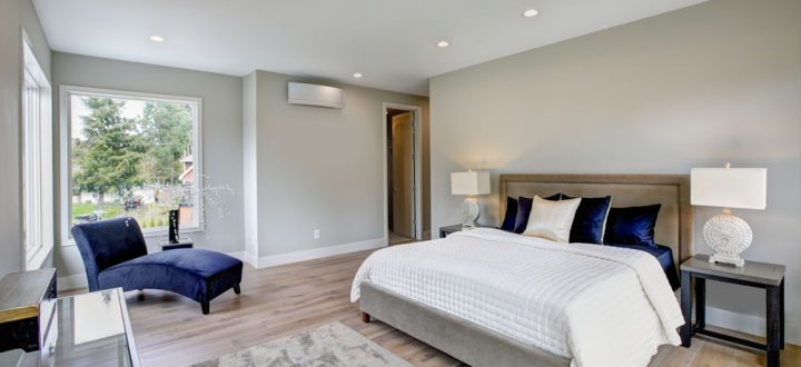 A warm and inviting bedroom decorated in earthy tones with textured bedding and wooden furniture, offering a cozy and tranquil atmosphere.